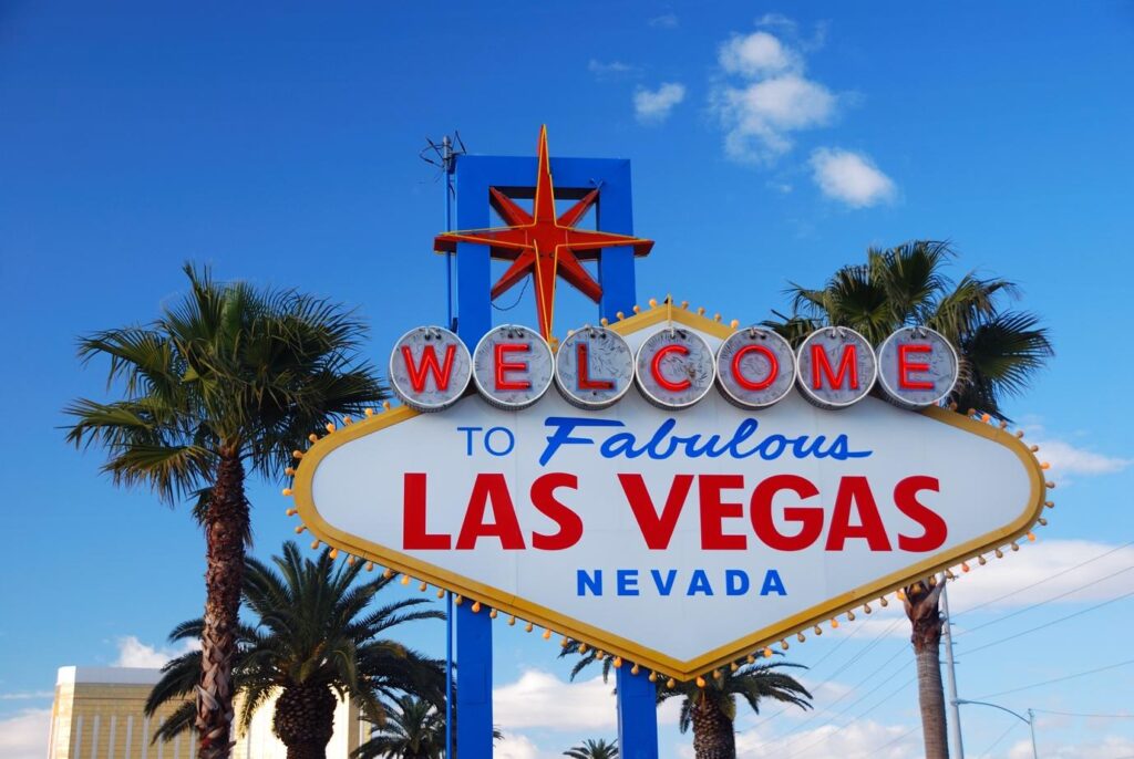 A close-up of a welcome sign with Welcome to Fabulous Las Vegas sign in the backgroundAI-generated content may be incorrect.